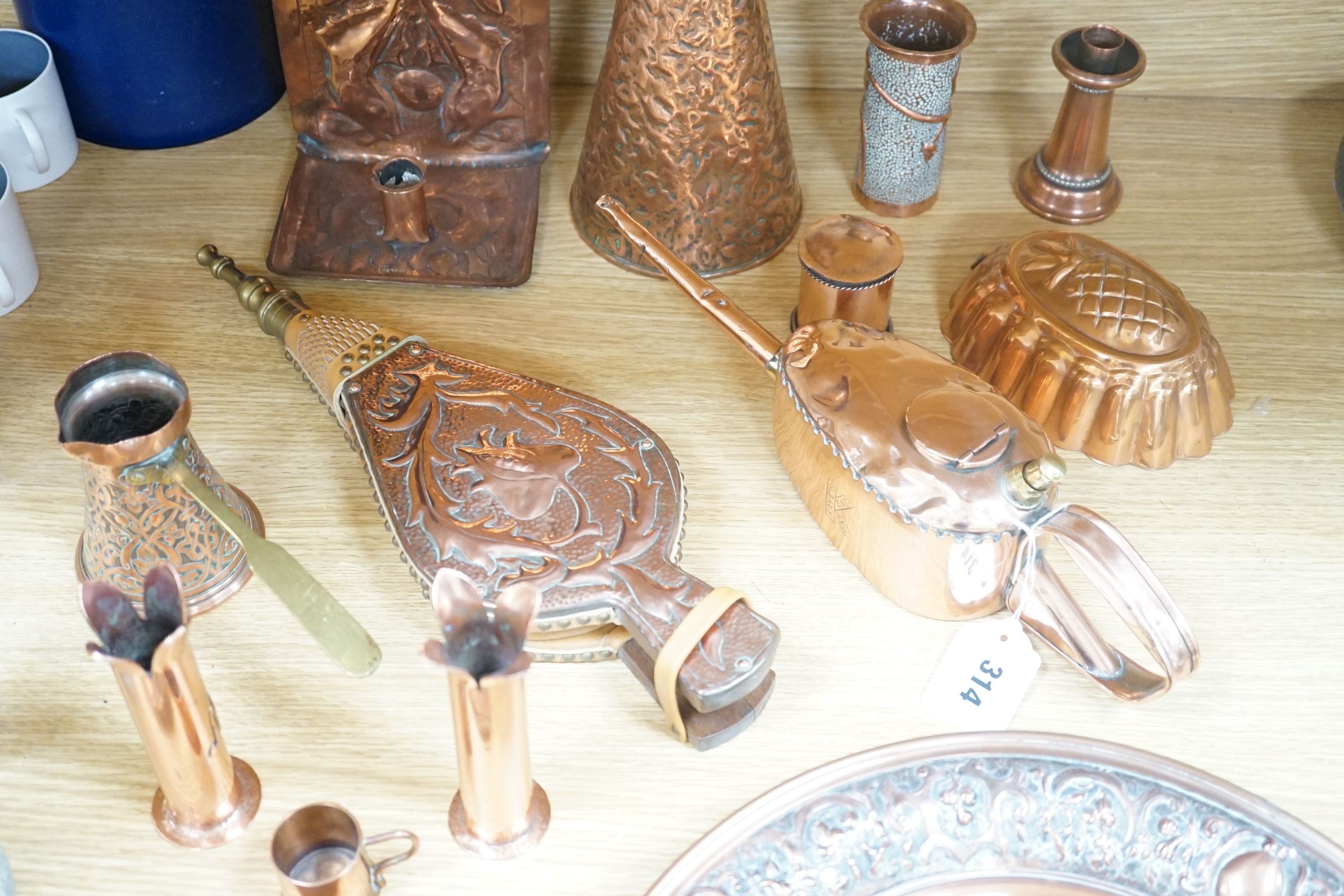 A Newlyn copper wall sconce, 24cm, a quantity of copperware including a decorative plaque and jelly mould
